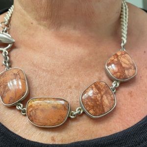 Handmade necklace- stones are a brownish - almost cinnamon shade.